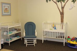 Rocker, crib and changing station in church nursery.